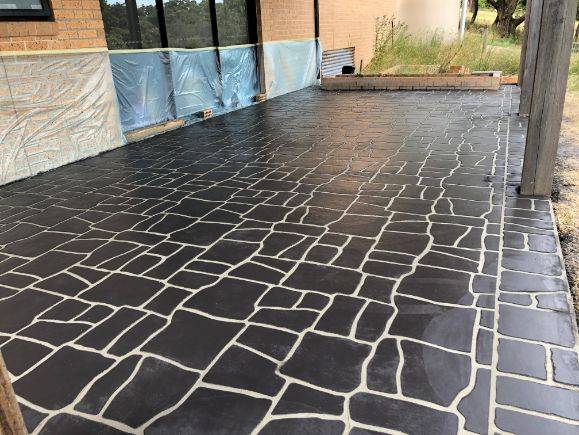 Ballarat Pro Concreters team of concreters Ballarat finishing a stenciled concrete slab on a patio in Golden Point Ballarat